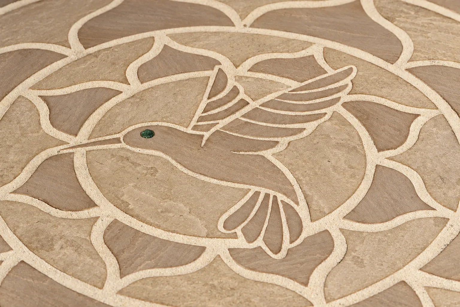 Bespoke stone floor with a hummingbird mosaic